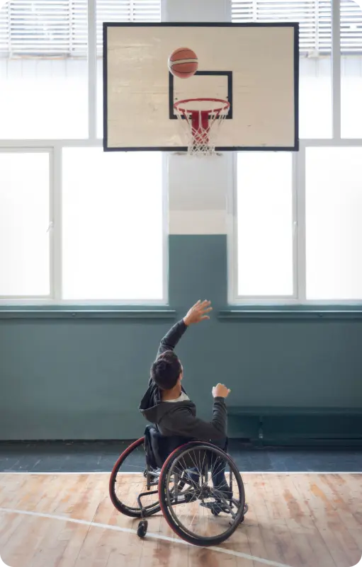Girl in a wheel chair trying to hoop